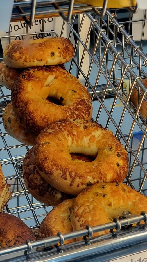 Fresh jalapeno cheddar bagels in the cooling rack at DeLand Bagel